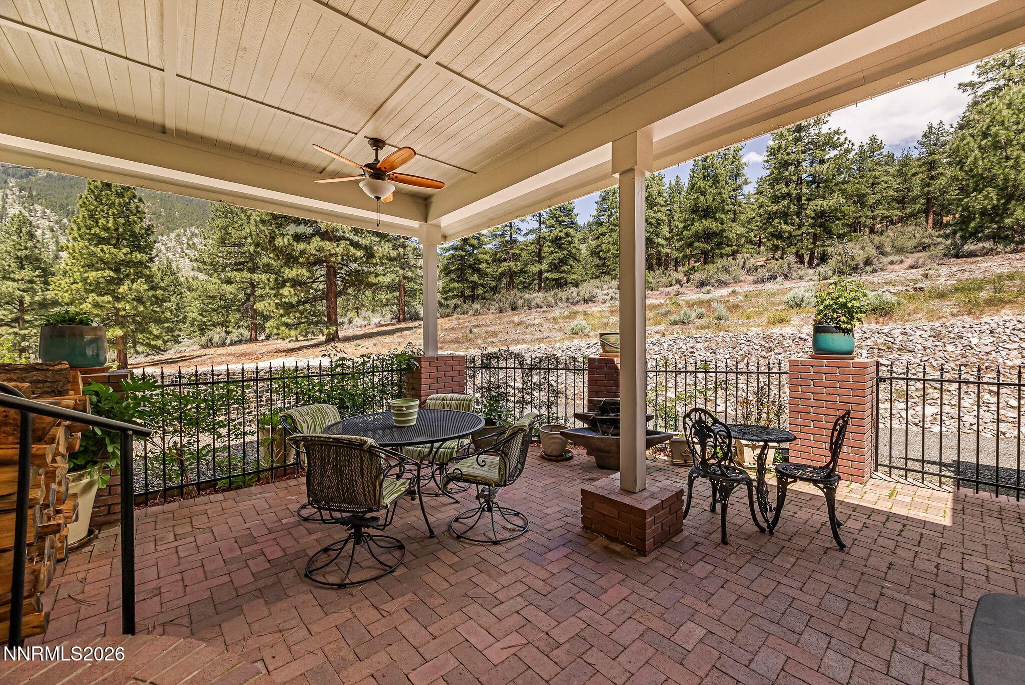 250 Jacks Valley Ranch Road Carson City, NV 89705 - Photo 32 of 44 a view of a patio with table and chairs and floor to ceiling window