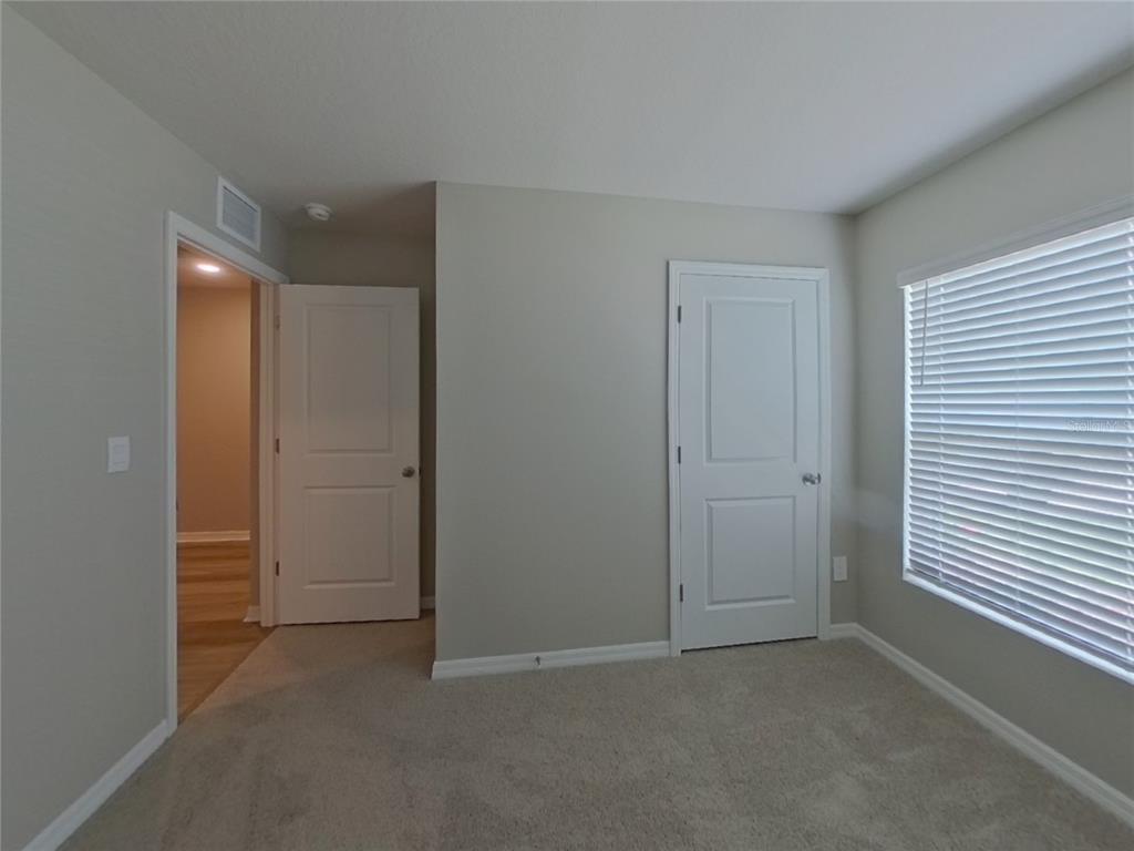 10844 Gentle Current Way Parrish, FL 34219 - Photo 12 of 17 an empty room with closet and windows