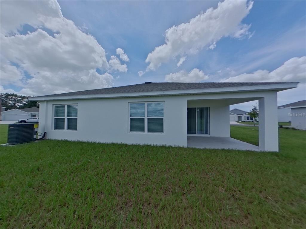 10844 Gentle Current Way Parrish, FL 34219 - Photo 16 of 17 a backyard of a house with table and chairs