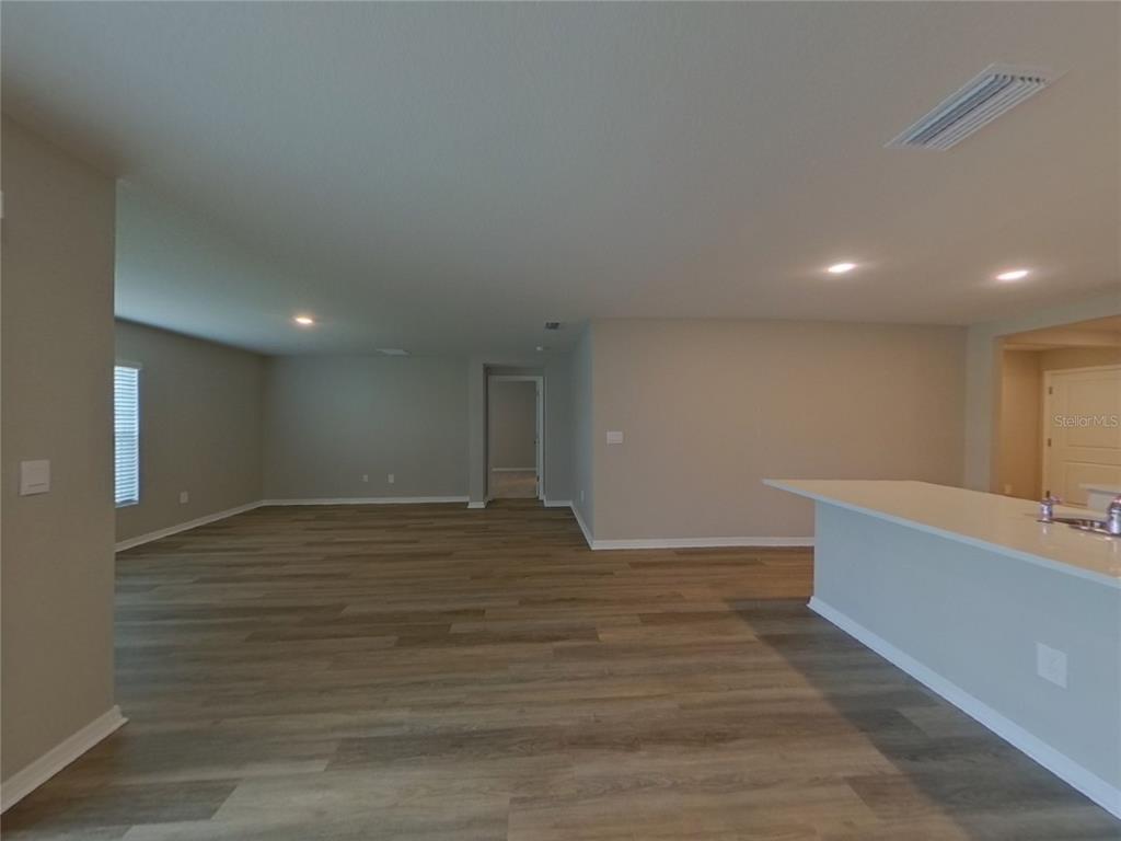 10844 Gentle Current Way Parrish, FL 34219 - Photo 5 of 17 a view of an empty room with wooden floor