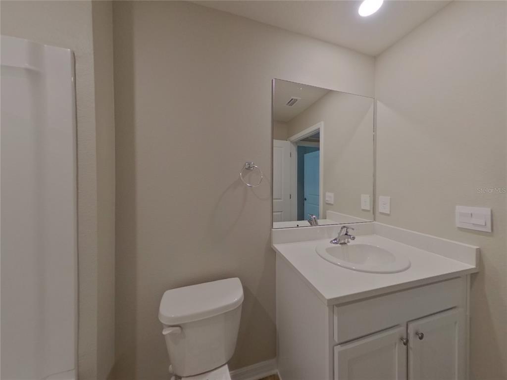 10844 Gentle Current Way Parrish, FL 34219 - Photo 9 of 17 a bathroom with a toilet sink and mirror