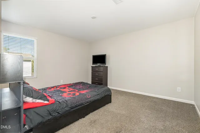 a bedroom with a bed and a fireplace