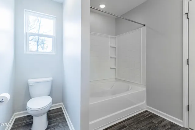 a bathroom with a toilet and a bathtub
