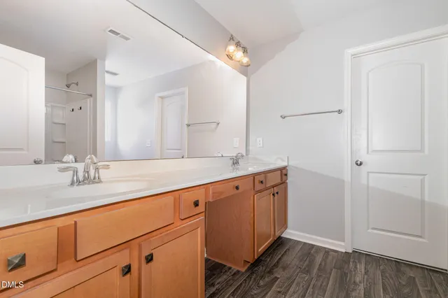 a bathroom with a double vanity sink and a mirror