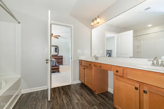a spacious bathroom with a double vanity sink and a mirror