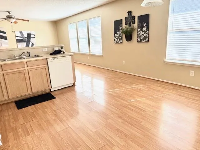 a kitchen with a cabinets and wooden floor
