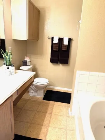 a bathroom with a sink a toilet and mirror