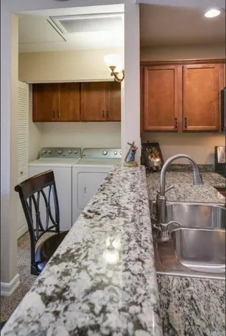 a kitchen with a sink stove and cabinets