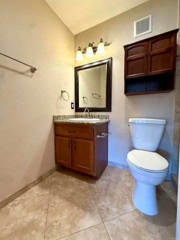 a bathroom with a toilet a sink and a mirror