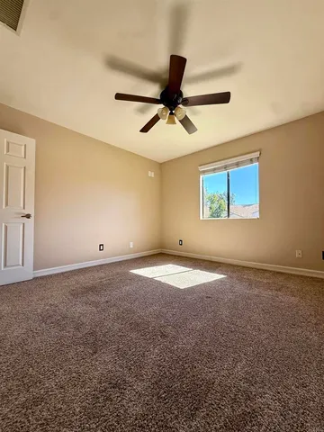 a view of empty room with ceiling fan