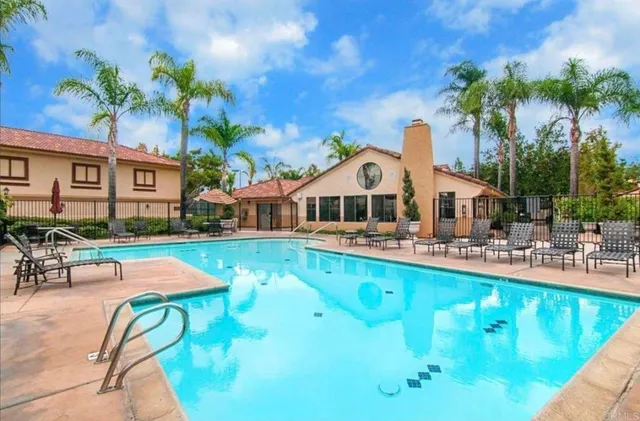 a view of a swimming pool with a patio and a garden