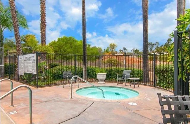 a swimming pool with outdoor seating and yard