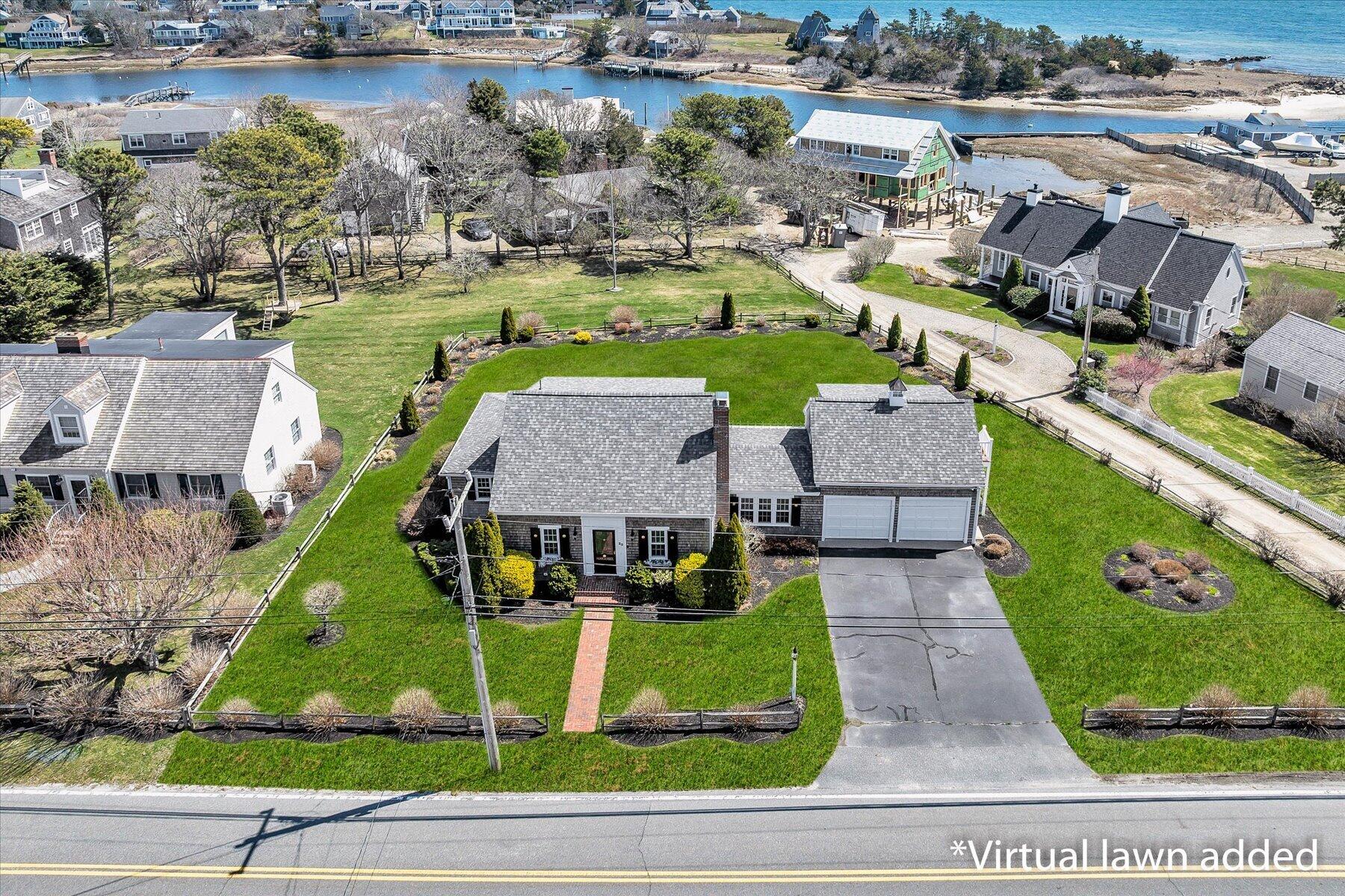 an aerial view of a house with garden space and street view