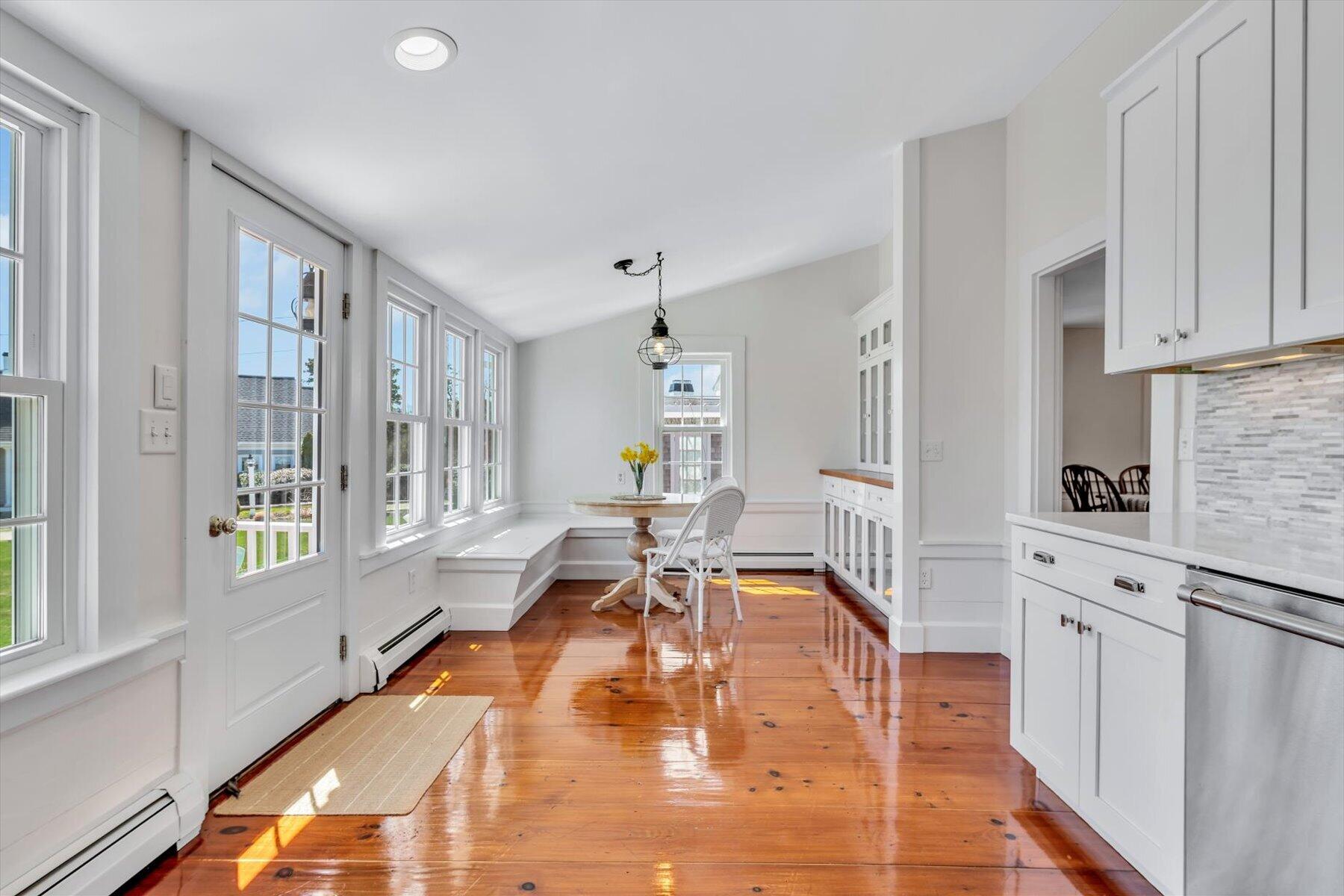 25 Riverside Drive West Harwich, MA 02671 - Photo 16 of 41 a living room with furniture a dining table chairs and large windows