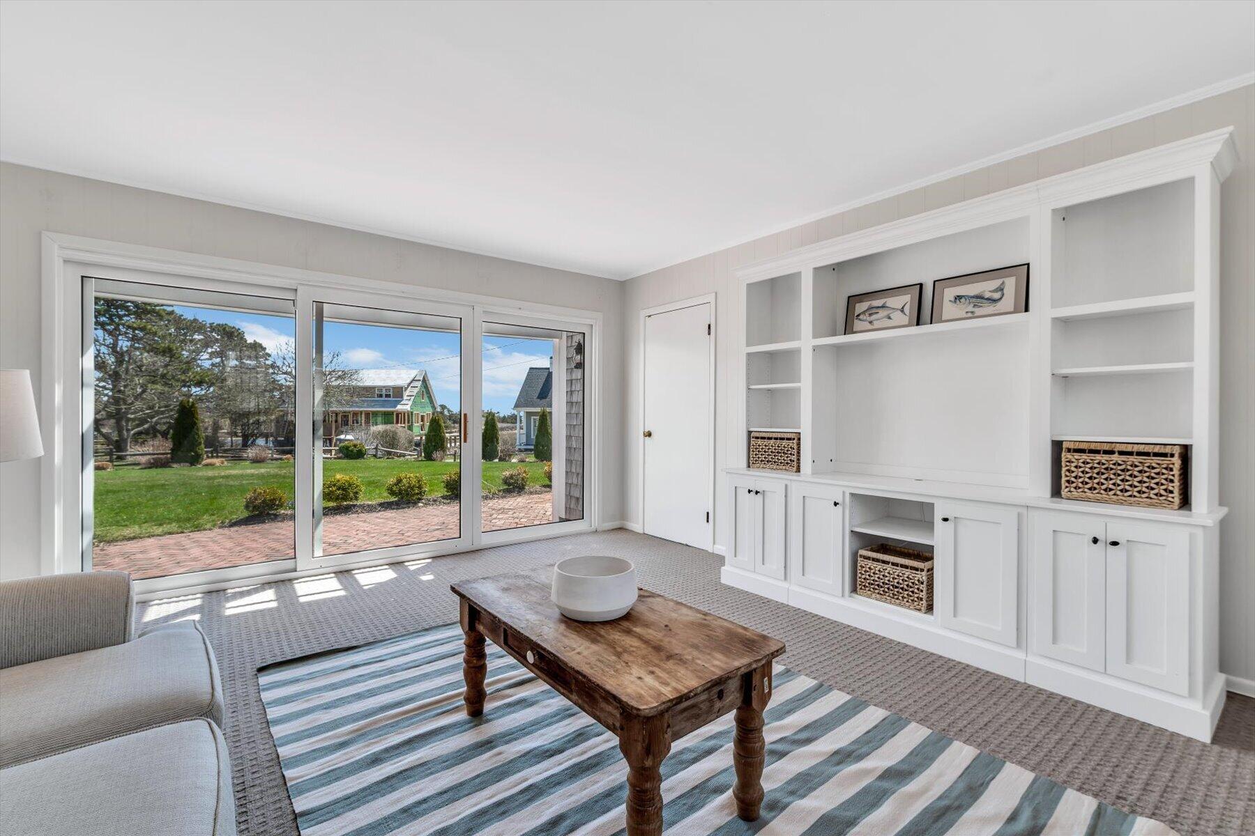 25 Riverside Drive West Harwich, MA 02671 - Photo 19 of 41 a living room with furniture and a floor to ceiling window