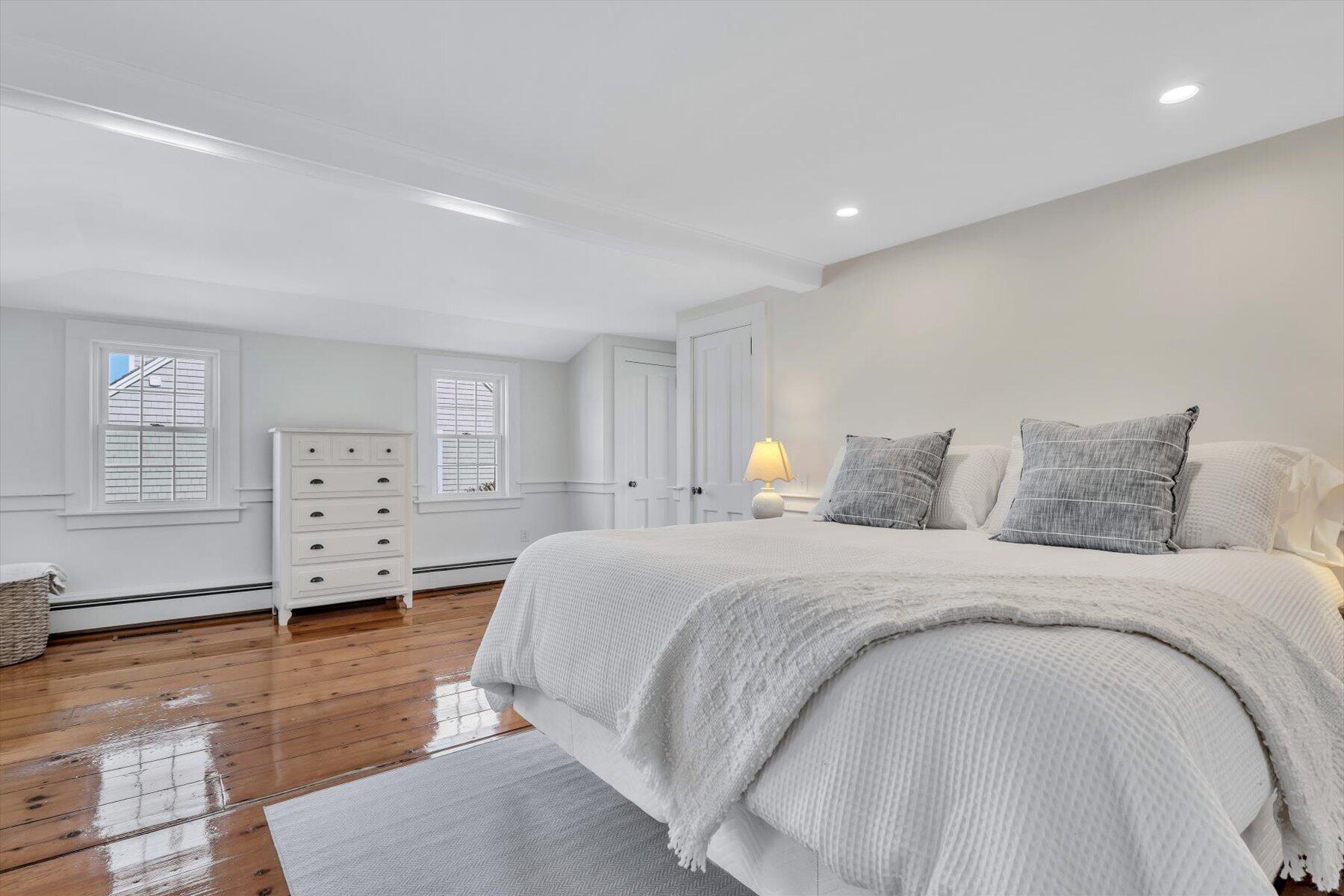 25 Riverside Drive West Harwich, MA 02671 - Photo 23 of 41 a spacious bedroom with a bed and wooden floor