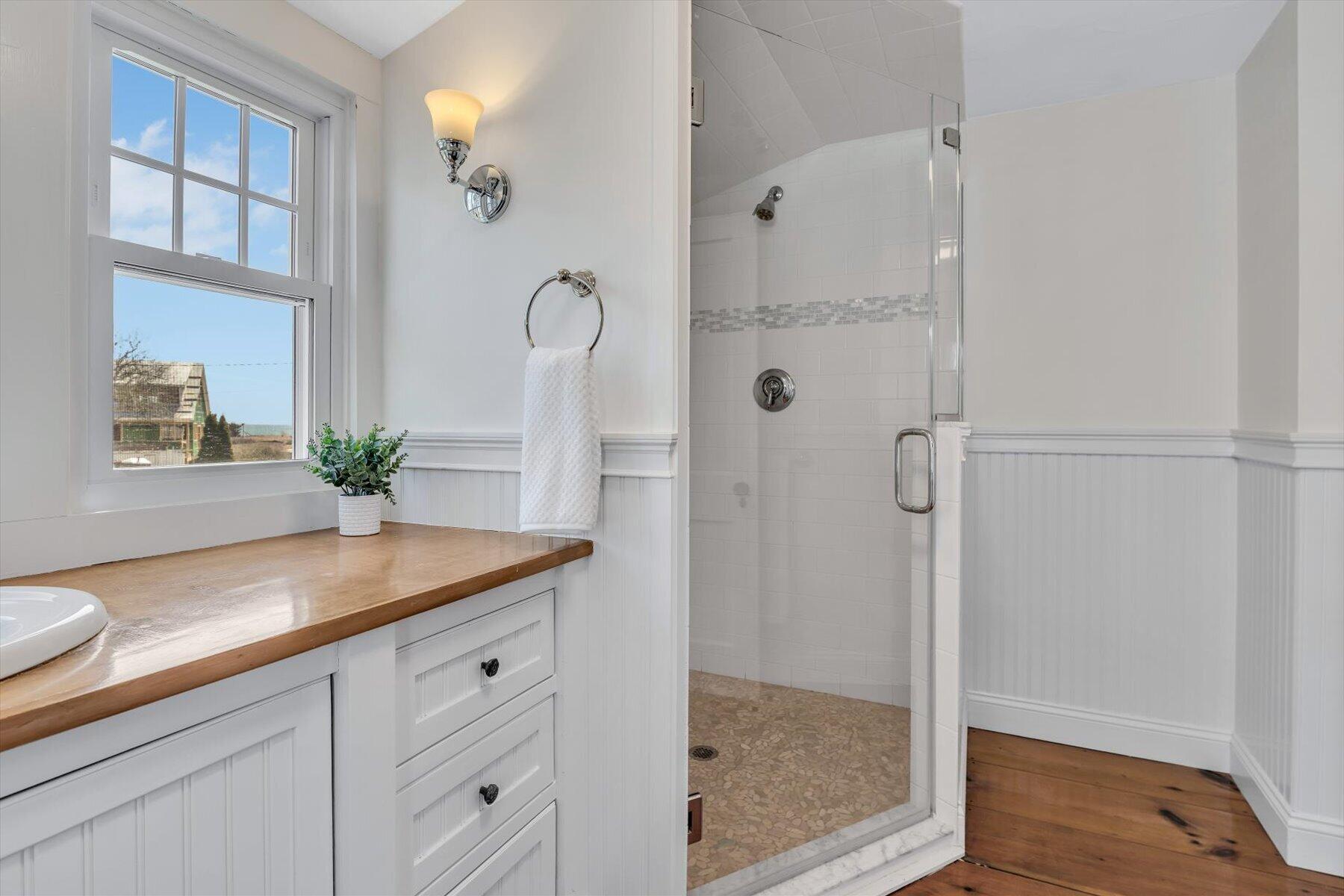 25 Riverside Drive West Harwich, MA 02671 - Photo 26 of 41 a bathroom with a granite countertop sink a mirror and a shower
