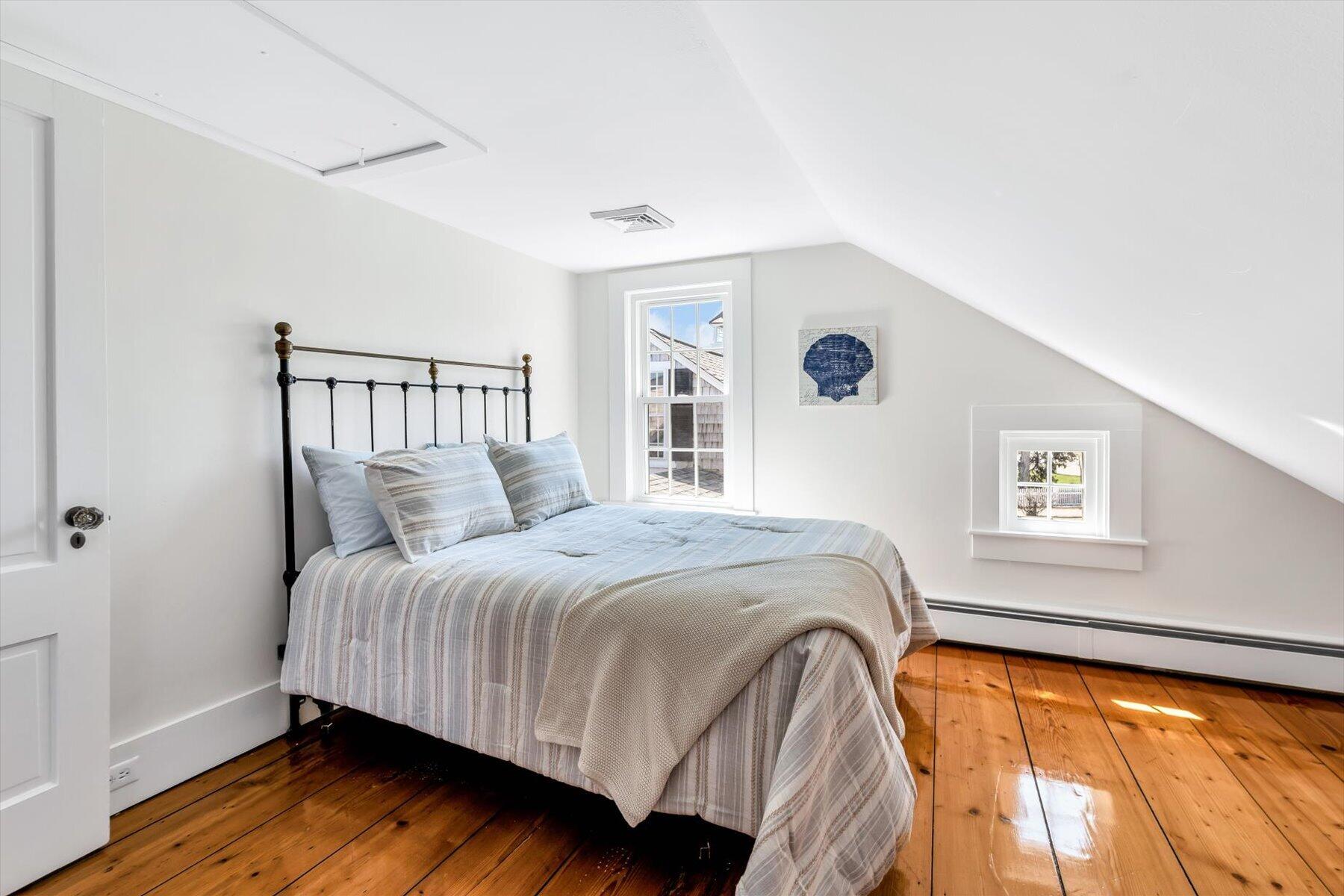 25 Riverside Drive West Harwich, MA 02671 - Photo 30 of 41 a bedroom with a bed and wooden floor