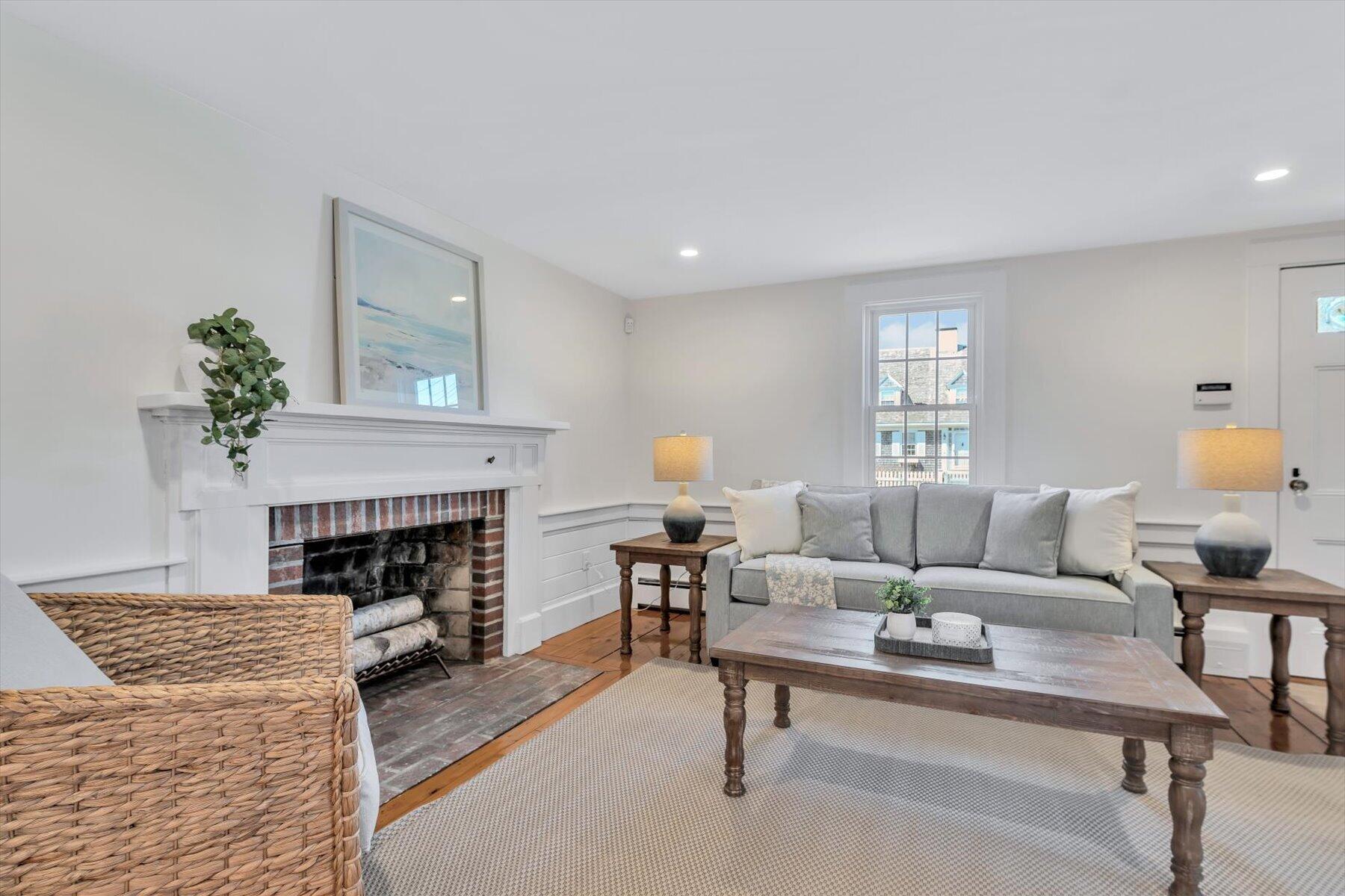 25 Riverside Drive West Harwich, MA 02671 - Photo 8 of 41 a living room with furniture and a fireplace