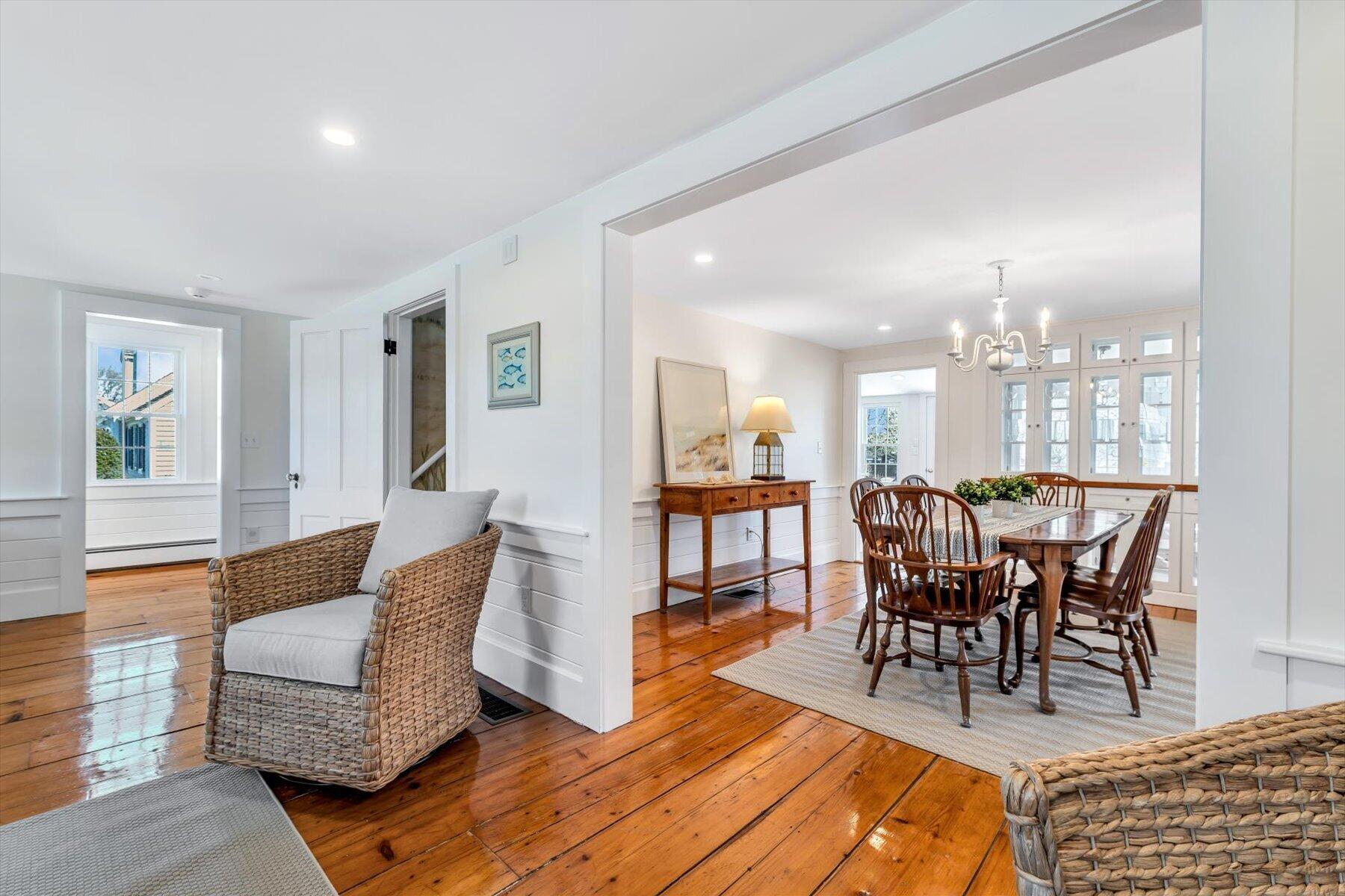 25 Riverside Drive West Harwich, MA 02671 - Photo 10 of 41 a view of a a dining room and livingroom with furniture wooden floor a rug and a chandelier