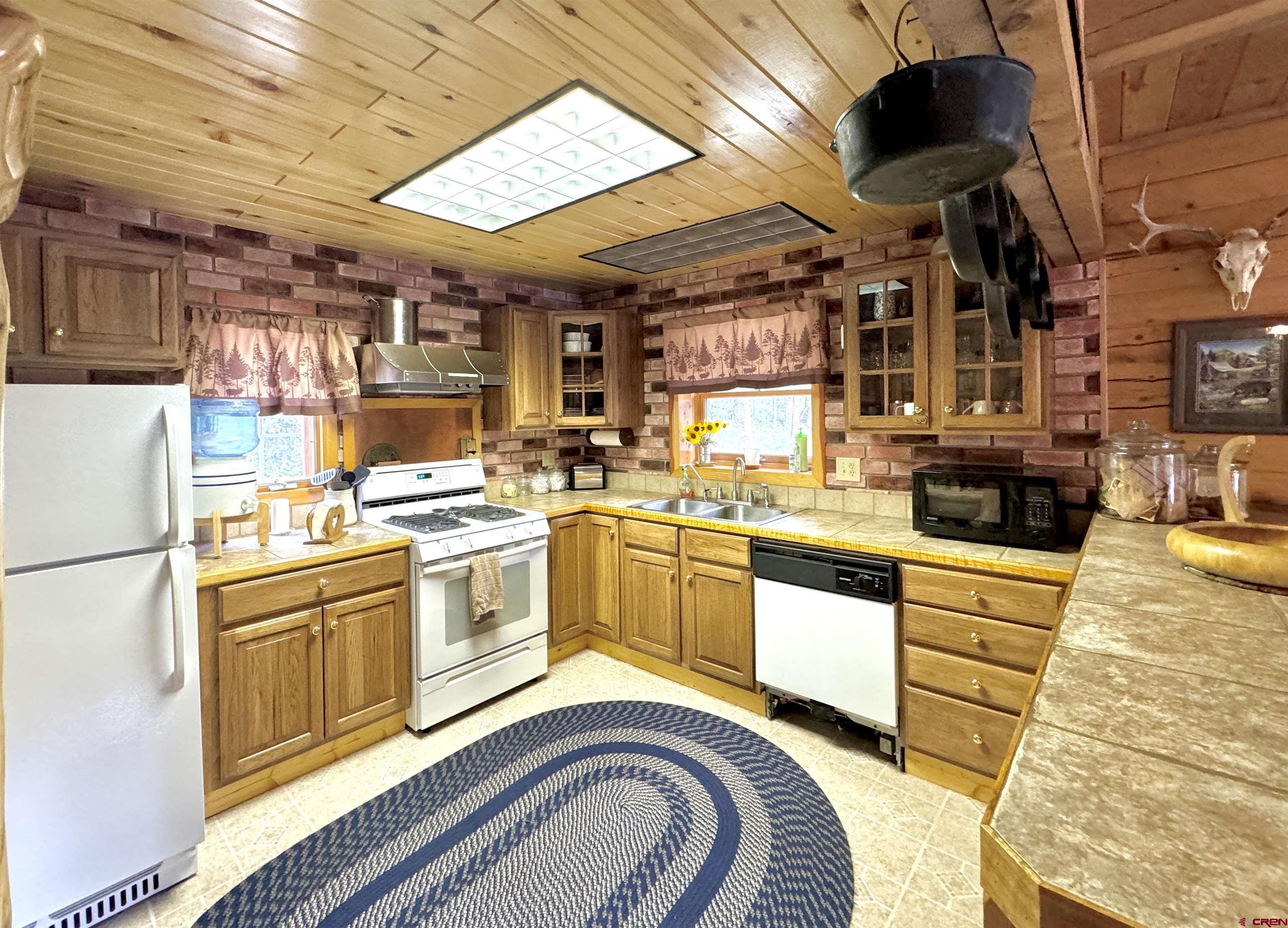 0 Forest Road Del Norte, CO 81132 - Photo 14 of 40 a kitchen that has a lot of white cabinets and stainless steel appliances