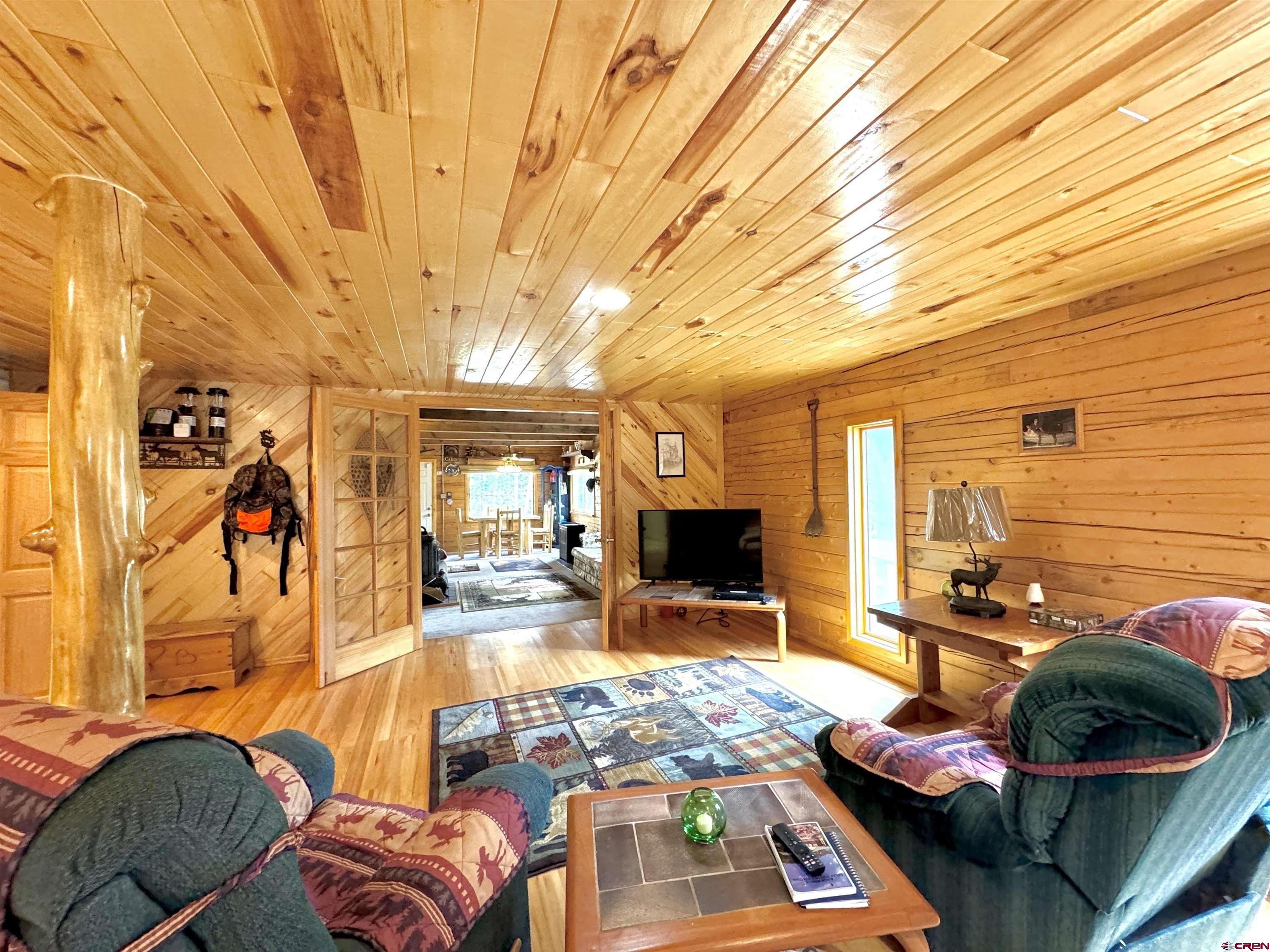 0 Forest Road Del Norte, CO 81132 - Photo 26 of 40 a living room with furniture and a flat screen tv
