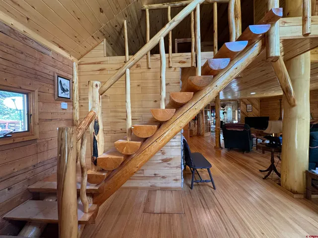 a blue and white bed sitting in a room next to a window