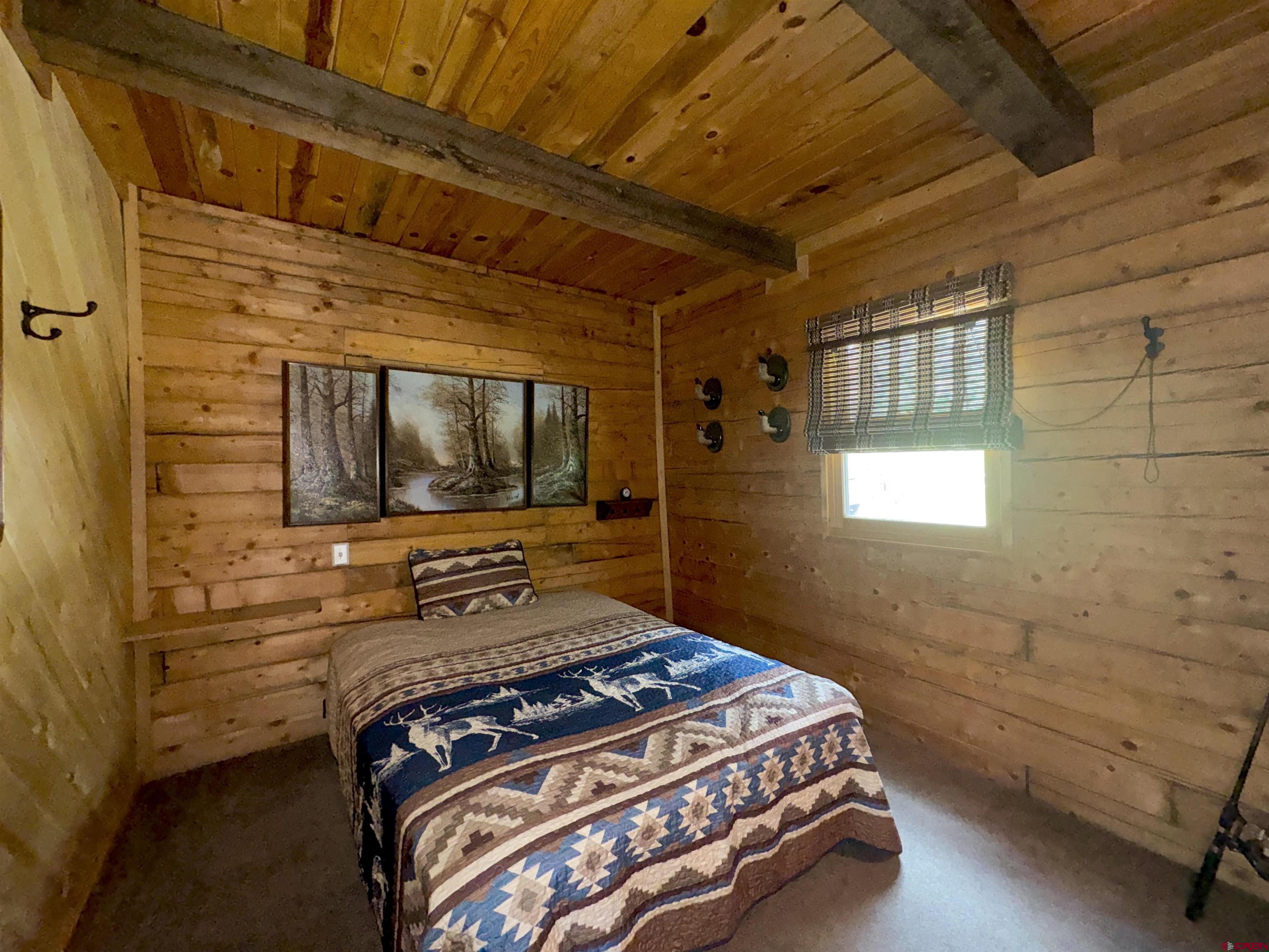 0 Forest Road Del Norte, CO 81132 - Photo 3 of 40 a bedroom with a bed and a flat tv screen