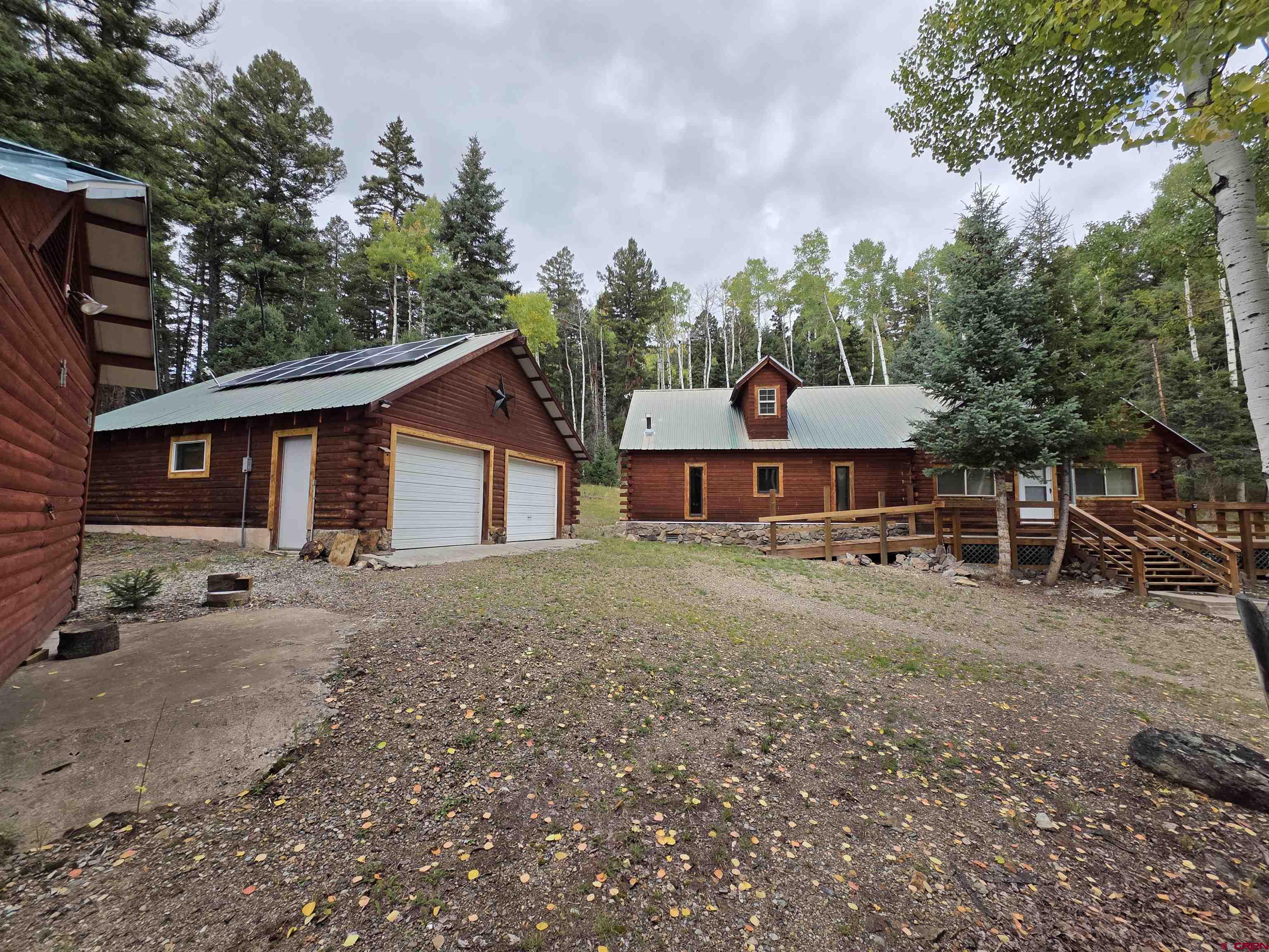 0 Forest Road Del Norte, CO 81132 - Photo 38 of 40 a front view of a house with a garden and trees
