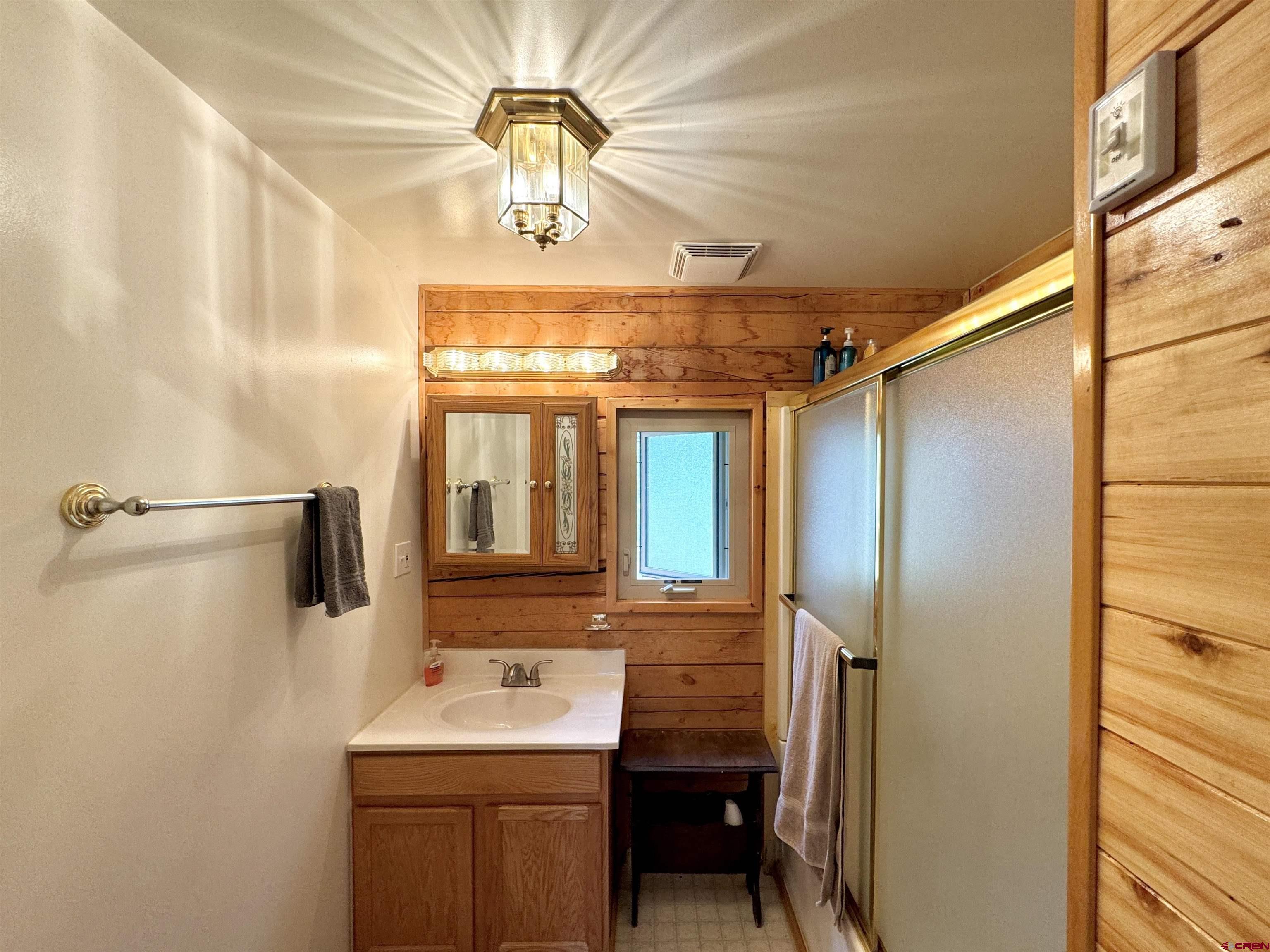 0 Forest Road Del Norte, CO 81132 - Photo 10 of 40 a bathroom with a sink a mirror and a shower