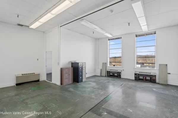 a view of a bedroom with furniture and windows