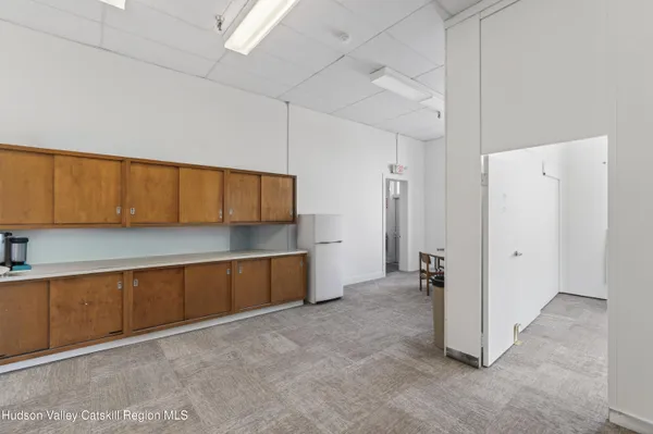 a view of a kitchen with a sink and cabinets