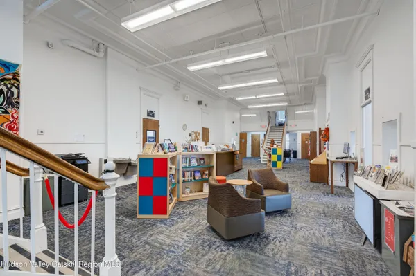 a living room with lots of furniture and a rug