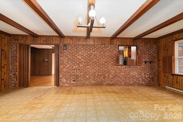 a view of a room with a gallery and wooden floor
