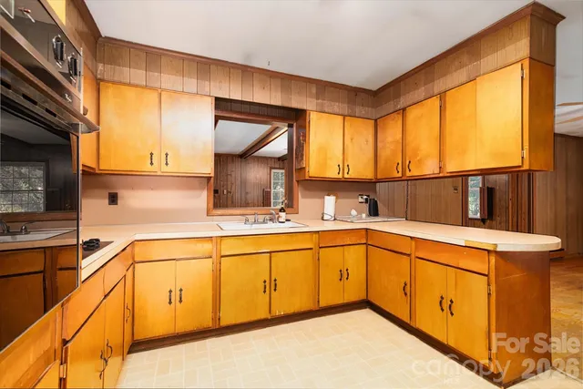 a kitchen with a refrigerator and a more cabinets