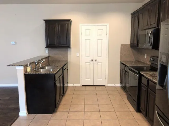 a kitchen with a refrigerator and a sink