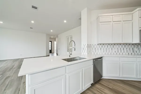 a kitchen with a sink and cabinets