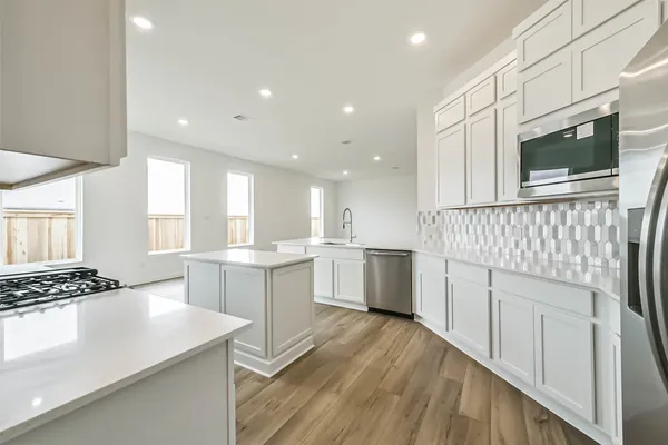 a kitchen with a sink stove and microwave
