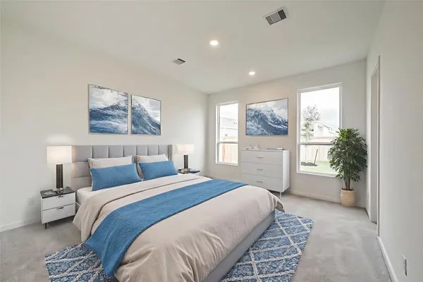 a spacious bedroom with a large bed and a large window