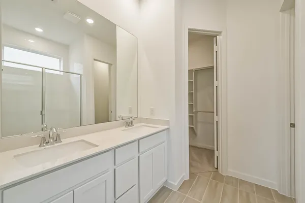 a bathroom with a glass shower door and a glass door