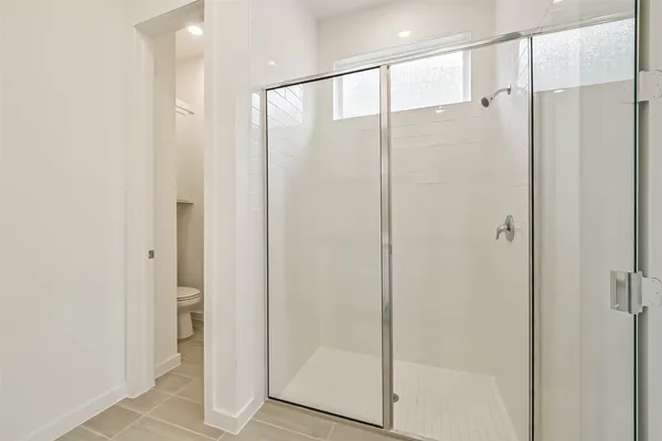 a bathroom with a shower and a sink