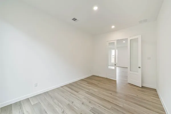 a living room with furniture a rug and a bookshelf