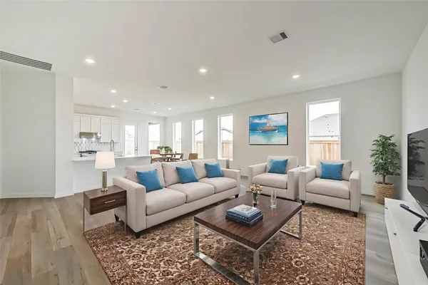 a living room with furniture or kitchen and a wooden floor