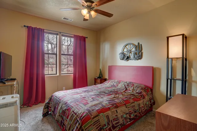 a bedroom with a large bed and a window