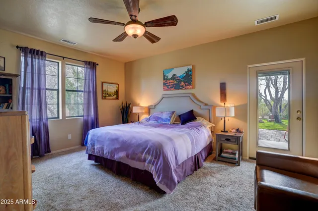 a bedroom with a bed and a large window