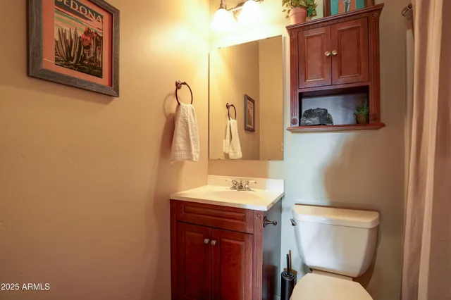 a bathroom with a toilet sink and mirror