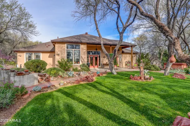 a front view of a house with patio and garden