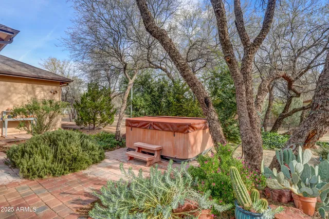 a backyard of a house with table and chairs