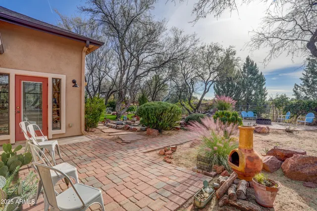 a backyard of a house with yard and outdoor seating
