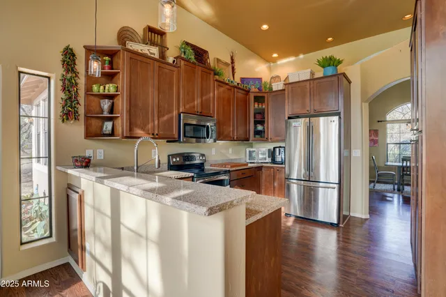 a kitchen with stainless steel appliances a refrigerator sink and cabinets